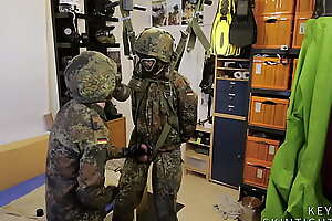 Two soldiers in German Flecktarn in effluvium masks wanking